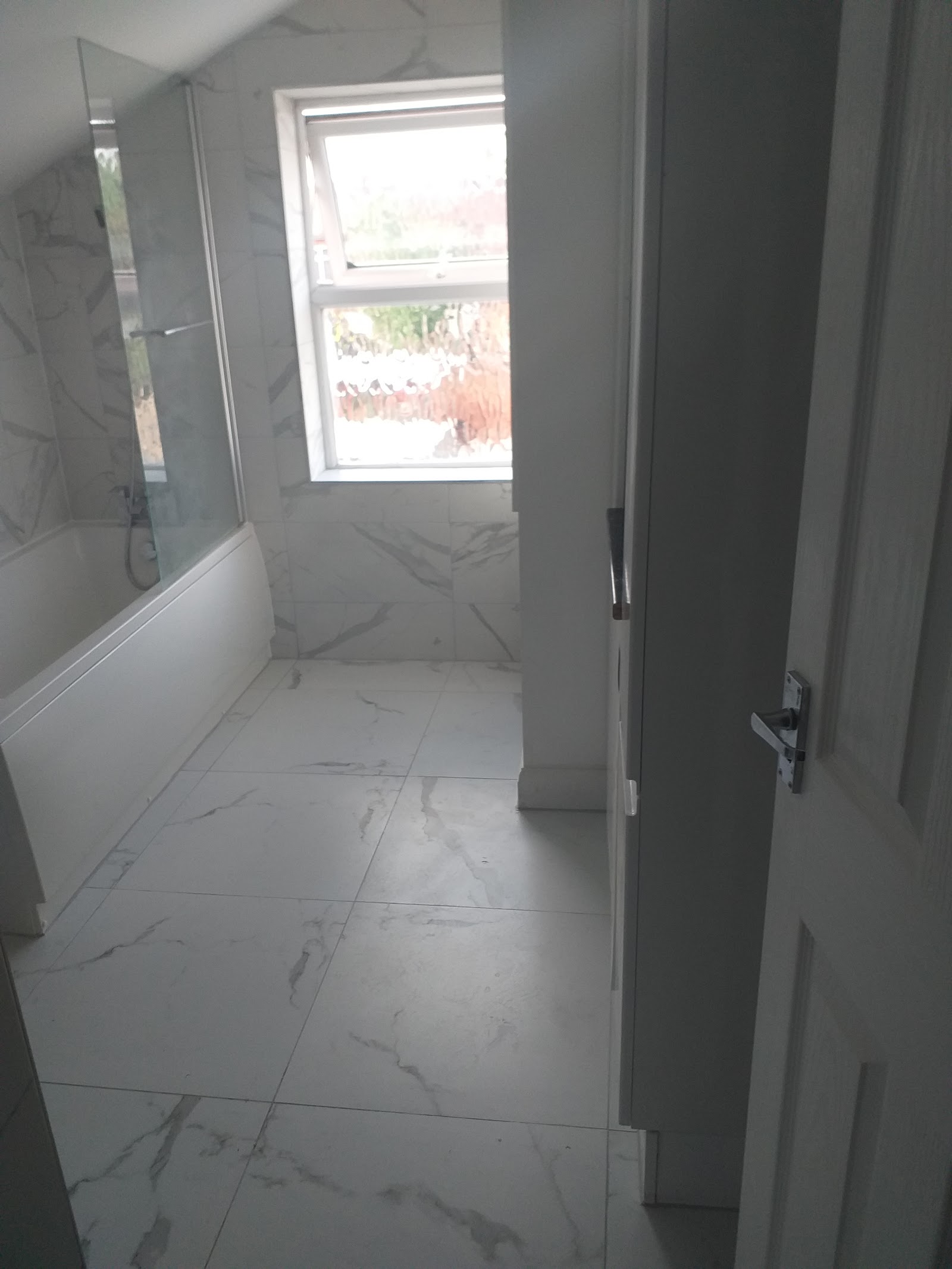 Finished marble-tiled bathroom installed by Betafix in Northampton